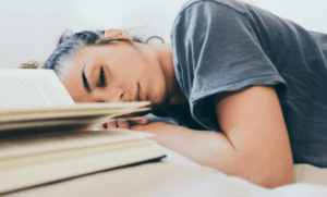 Jeune fille apaisée qui s'est endormie sur son bureau pendant qu'elle étudiait